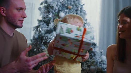 Family Celebrates Christmas with Gift Giving at Home