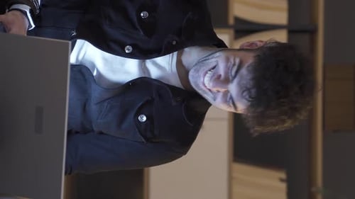 Man Typing on a Laptop Smiling
