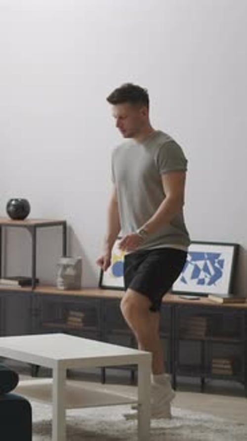 Man Does Step-Ups On Coffee Table At Home