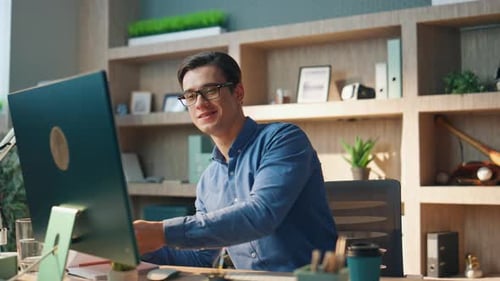 Smiling Creator Working Computer at Office Closeup. Inspired Happy Man Checking Notebook