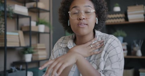 Young Woman Communicating Via Video Chat at Home