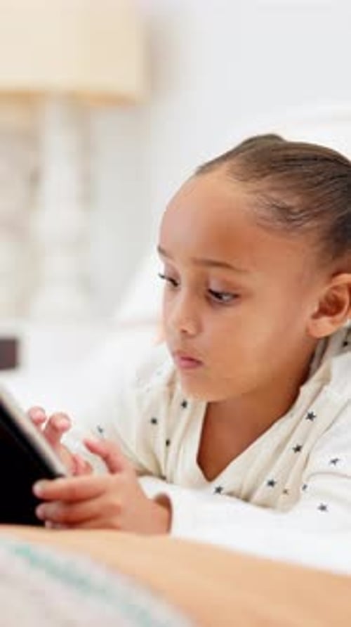 Girl, kid and learning with tablet for interaction, entertainment or childhood in bedroom