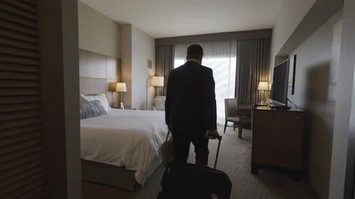 Business Man in Suit Entering Hotel Room - Exhausted Falling Back on Bed