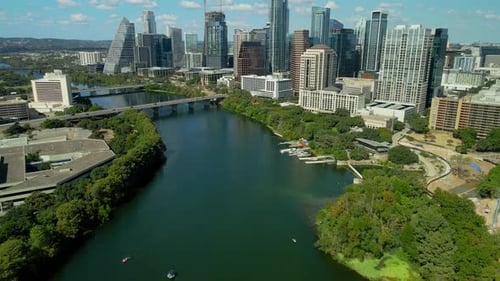 Drone shot revealing downtown Austin next to the Colorado River. Establishing Aerial view of Austin