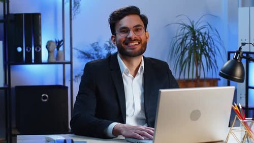 Portrait of Happy Smiling Bearded Indian Business Man at Home Office Look Away Turn Head at Camera