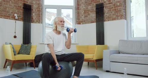 Senior Man Working Out with Dumbbells at Home