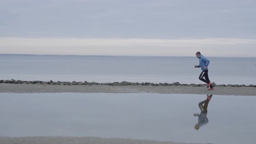 Top View of a Man on a Morning Jog Near the Lake