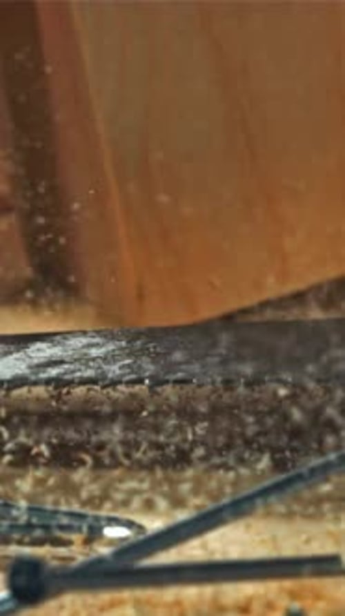 A Hand Saw Falls on the Carpenter's Worktable Filmed on a Highspeed Camera at 1000 Fps