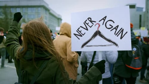 People Protesting with Signs in City