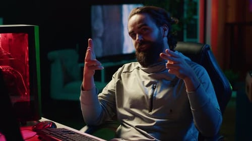 Man Sitting at Desk with Computer Talking