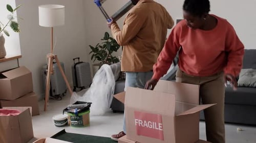 Family unpacks moving boxes in new home