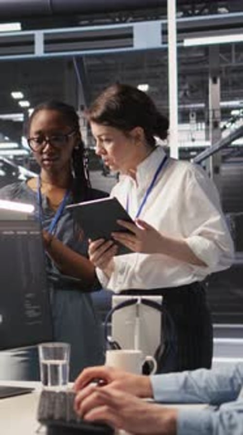 Vertical Video Software Developers Working Together in Server Farm Reviewing AI Code