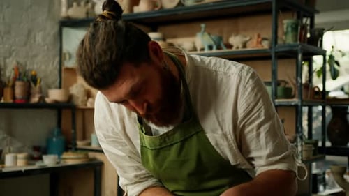 A man makes a clay pot on a ceramic wheel Ceramics Close-up A potter does pottery handicraft