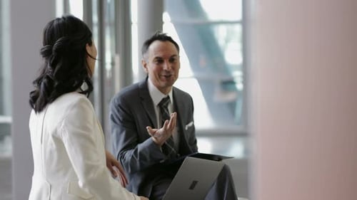 Business People with Laptop Talking and Laughing in Office Lobby 2024 Years