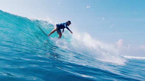 Man Surfs Ocean Wave in the Maldives