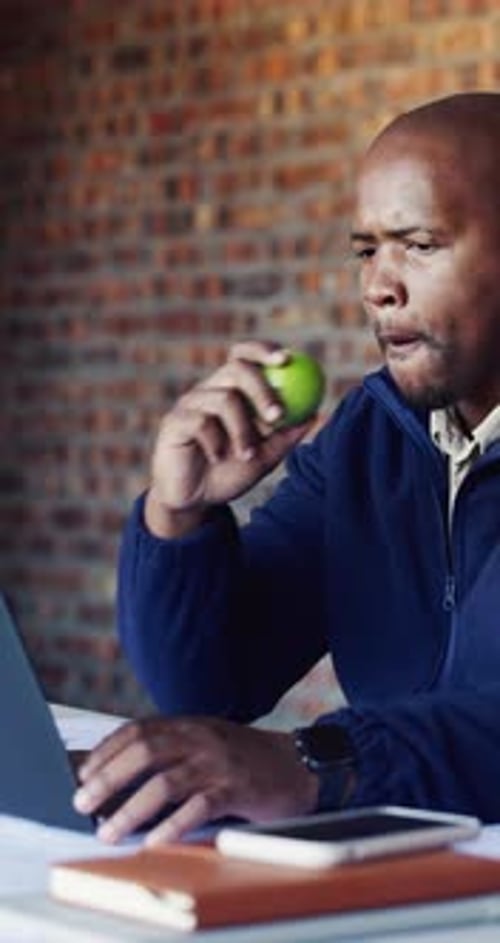 Architect, laptop and apple with black man on construction site for planning or research