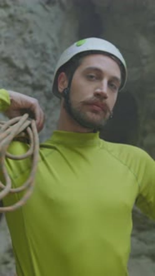 Rock Climber Maintains Focus Enthusiastic Climber in Safety Gear Demonstrates Calmness During Rocky