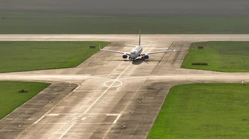 Airplane Taxiing on Runway from Aerial View