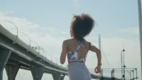 Young Woman Jogging Outdoors on City Street