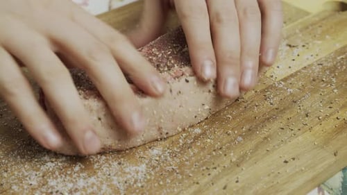 Adding spice onto meat steak on cutting board. Slow motion close up shot.