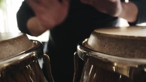 Man Playing Bongos Drumming Rhythmically Close Up