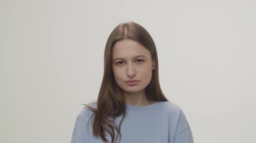 Woman Standing Silently Looking at Camera
