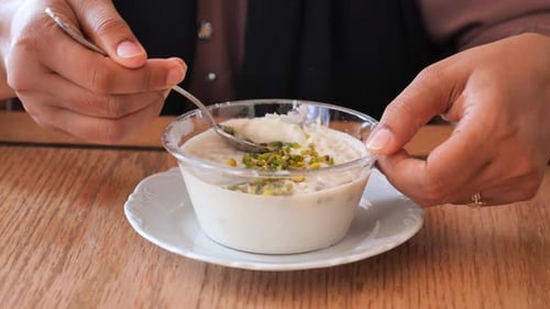 Women Eating Rice Pistachios Pudding