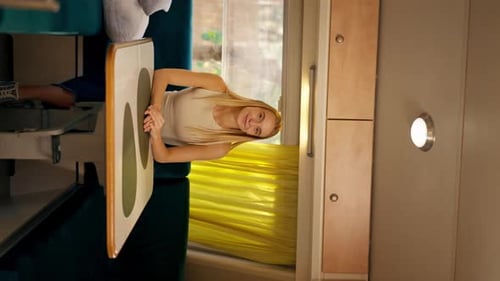 Smiling Woman Leans on Table in Train Car