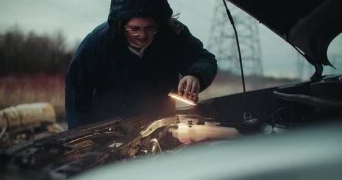 Woman Repairs Car Engine in Rural Setting