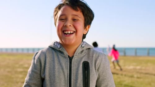 Face, funny and boy in park, child and summer holiday to relax, travel weekend and humor