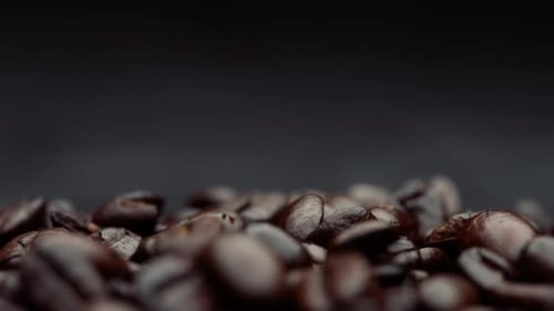 Roasted coffee beans falling in slow motion