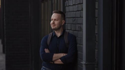 City Street Portrait of a Man in a Shirt and with a Backpack Modern Lifestyle in the City