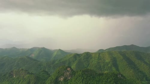 Mountains, green forest and drone with hills, clouds and landscape scenery