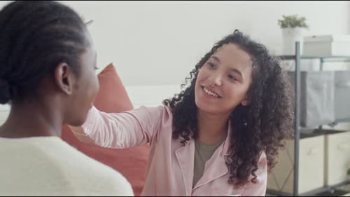Woman Applying Powder on Face of Girlfriend