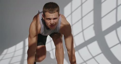 Man Exercising with Dumbbells in a Gym