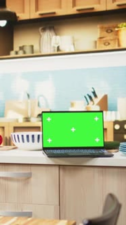 Vertical Video Green Screen on Laptop in the Kitchen with Rustic Counter and Elegant Lighting
