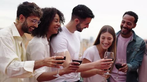 Friends Toasting with Wine on Urban Rooftop