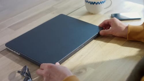 An Old Man Opens a Laptop in a Restaurant Remote Work of a Freelancer in a Coworking Grandpa is an