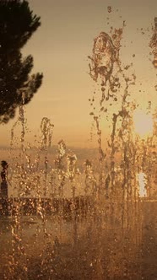 Serene Sunset Behind a Beautiful Fountain Creating a Dreamy and Tranquil Atmosphere