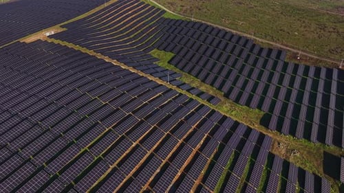 Solar panel field generates energy in open landscape
