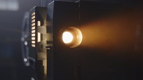Vintage Film Projector Shining in the Dark
