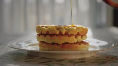 Maple Syrup Poured on Stack of Golden Waffles