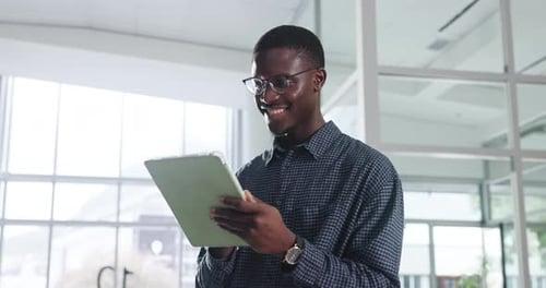 Tablet, business or happy black man in office for networking, research or journalist reading