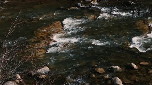Fast flow of water on a mountain river. Beautiful mountain river.