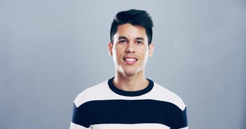 Man Smiles and Winks at the Camera