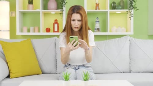 Stressed Woman Using Smartphone on Couch at Home