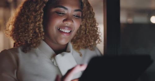 Woman Using Tablet at Night in Office