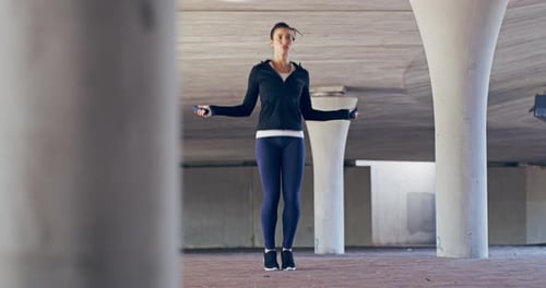 Athletic Woman Jumping Rope in an Urban Area