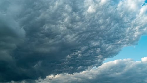 Dark Storm Clouds Rolling in a Blue Sky