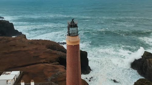 Lighthouse on Rocky Coast with Crashing Waves, Aerial